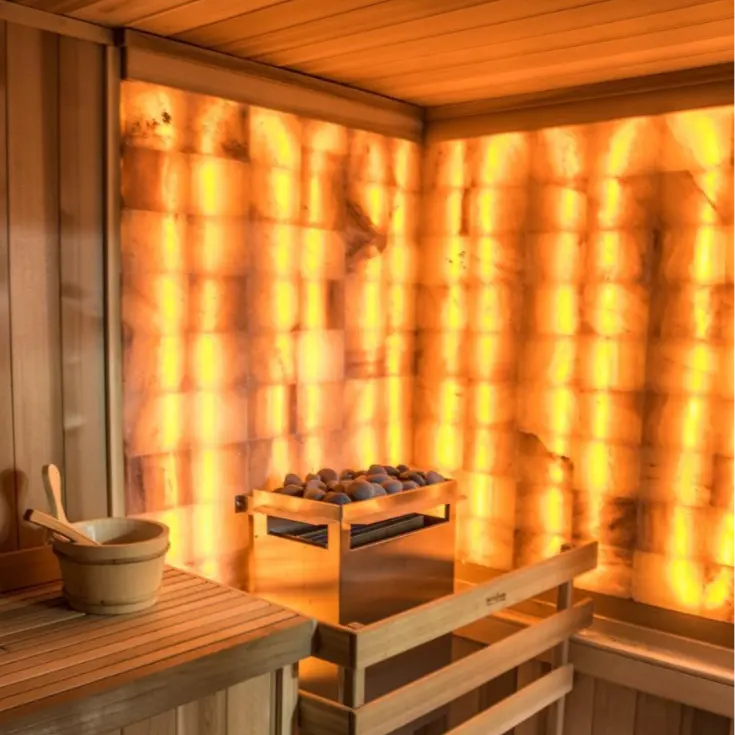 Sauna featuring a full Himalayan salt wall with warm, glowing ambiance.