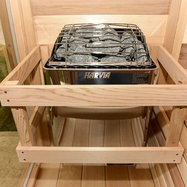 Harvia KIP 4.5KW Sauna Heater with a black metal housing, silver rock guard, and dark sauna stones visible above