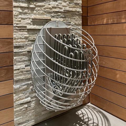 HUUM DROP 9kW Electric Sauna Heater with a rounded silver metal cage, exposed heating elements, and wall-mounted design
