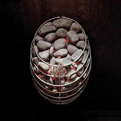 HUUM DROP 9kW Electric Sauna Heater with a rounded stainless-steel wire basket filled with sauna stones and glowing heating elements