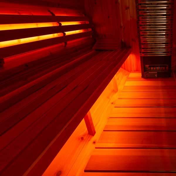 Leisurecraft Single Bench Sauna Light Set with warm amber LED strips glowing beneath dark wooden sauna benches