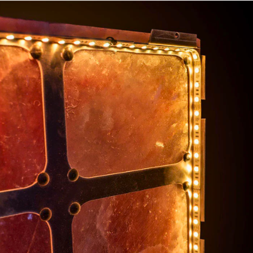 Backlit Himalayan salt wall panel providing ambient lighting in a sauna setting.