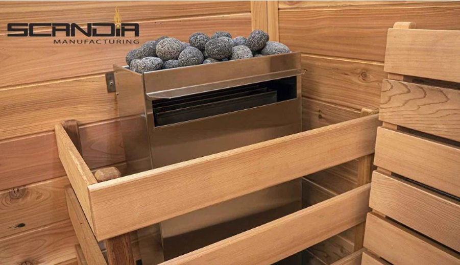 Scandia 7.5KW Electric Sauna Heater installed in a premium cedar sauna—stainless steel design with sauna stones for efficient, even heating. Wall-mounted with safety guardrails.