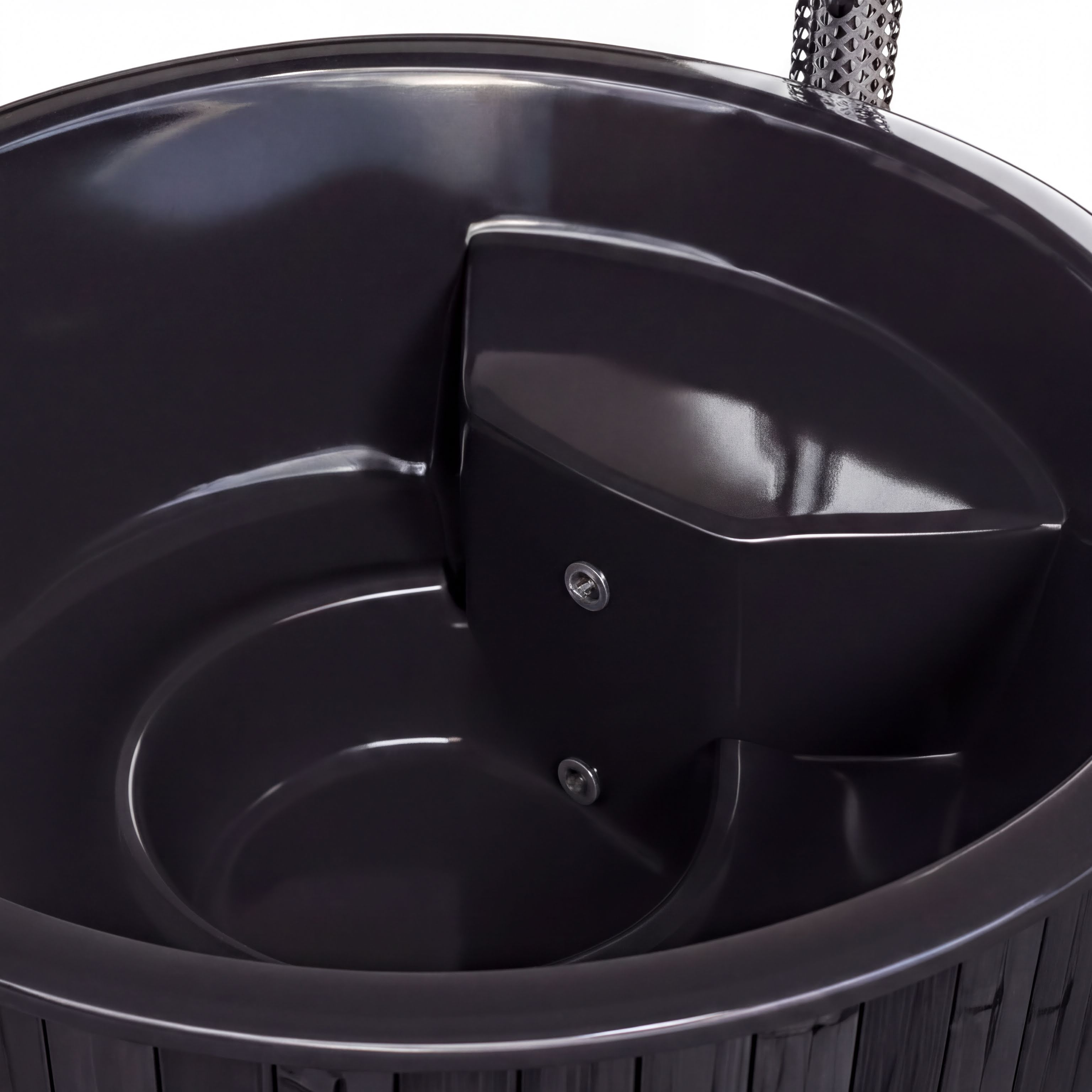 A dark-colored hot tub or spa with a curved, rounded shape and a small, rectangular attachment on the side.