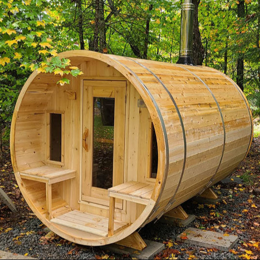 CTC2345W barrel sauna with wood-burning chimney in lush outdoor forest setting