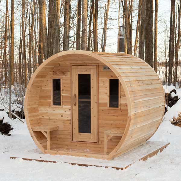 CTC2424W barrel sauna in snowy forest setting with front benches and triple-window design