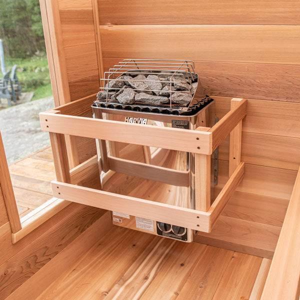 Harvia KIP 8KW Sauna Heater with a stainless steel body, gray sauna rocks, and protective wooden guard rails