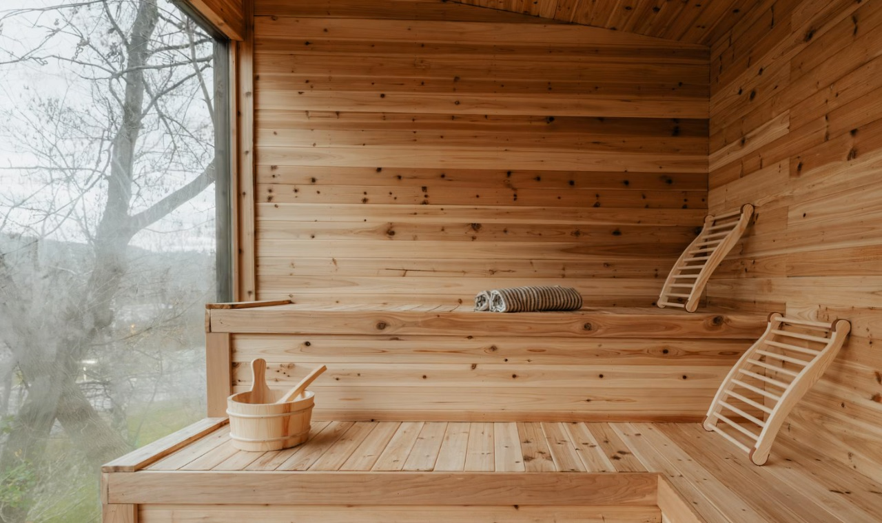 Luxury Cedar Sauna Interior with Wooden Benches, Bucket, and Natural Light – Relaxing Spa Atmosphere