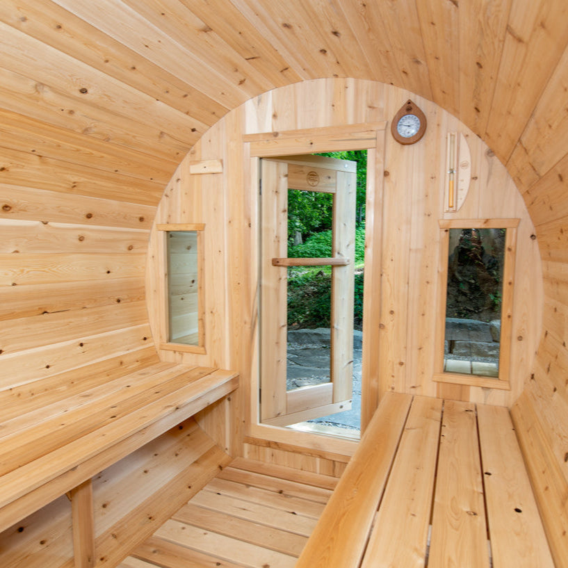 Side interior view of Tranquility Sauna showing cedar seating and stone heater