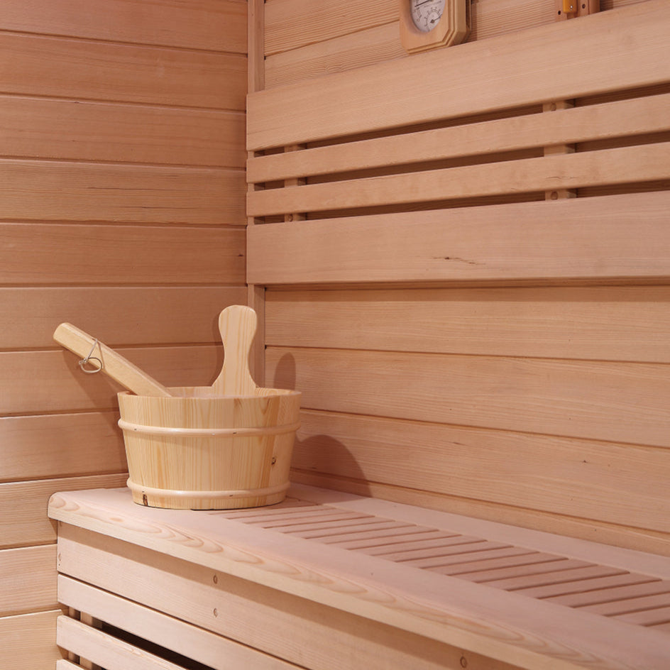 Interior bench and water bucket in Waja I002 sauna made from Hemlock wood