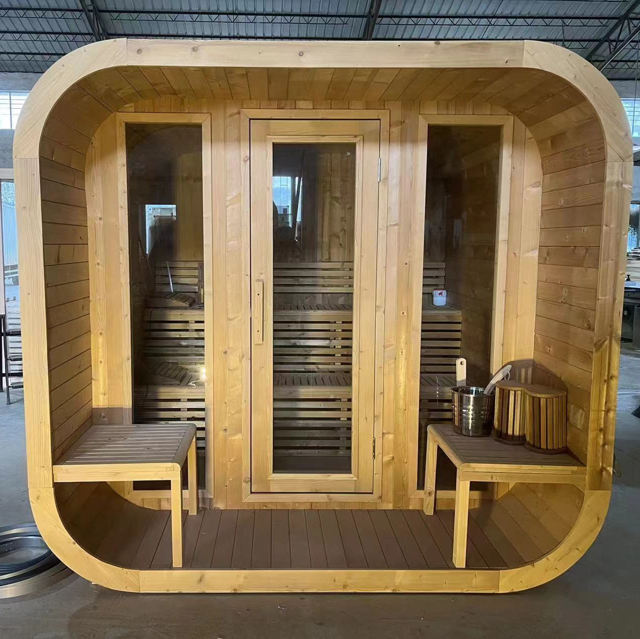 Waja Luna outdoor barrel sauna with full-glass doors and benches shown in Spruce wood finish