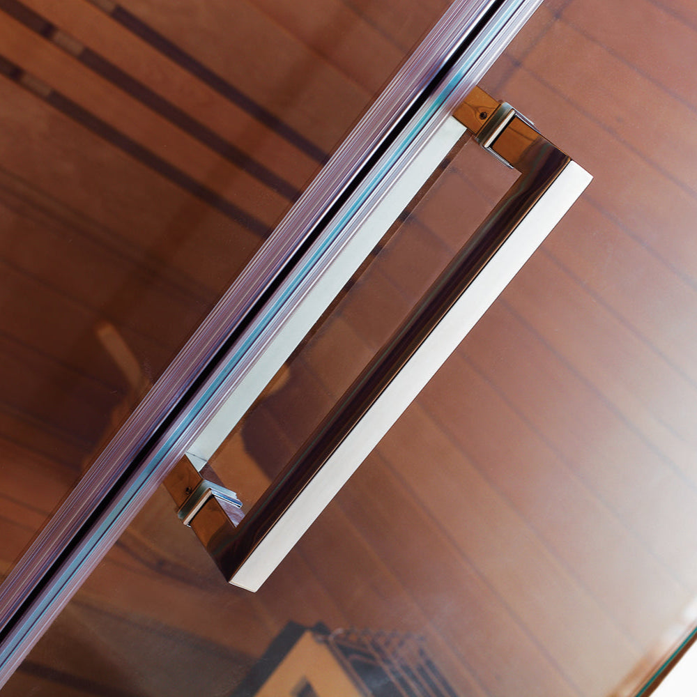 Close-up view of wooden and metal sauna door handle mounted on tempered glass