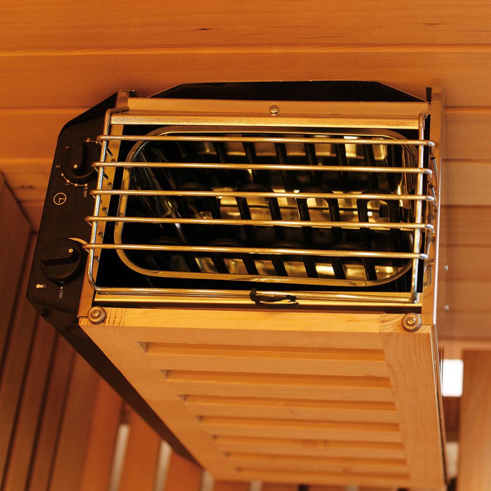View of electric sauna heater mounted inside Canadian Hemlock-paneled Waja sauna